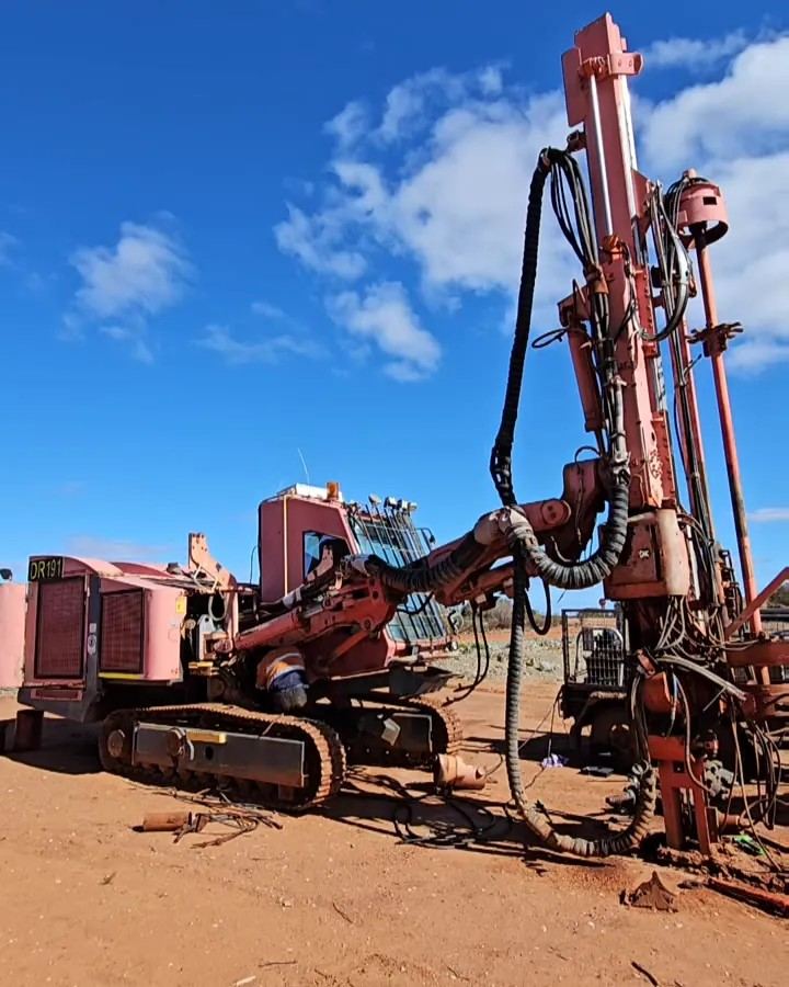 Stripped red drill rig being recovered from an old lease in remote Western Australia