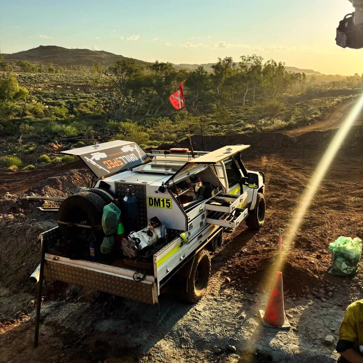 Drillspec DM15 field service ute carrying a replacement rotation pump on a red dirt track