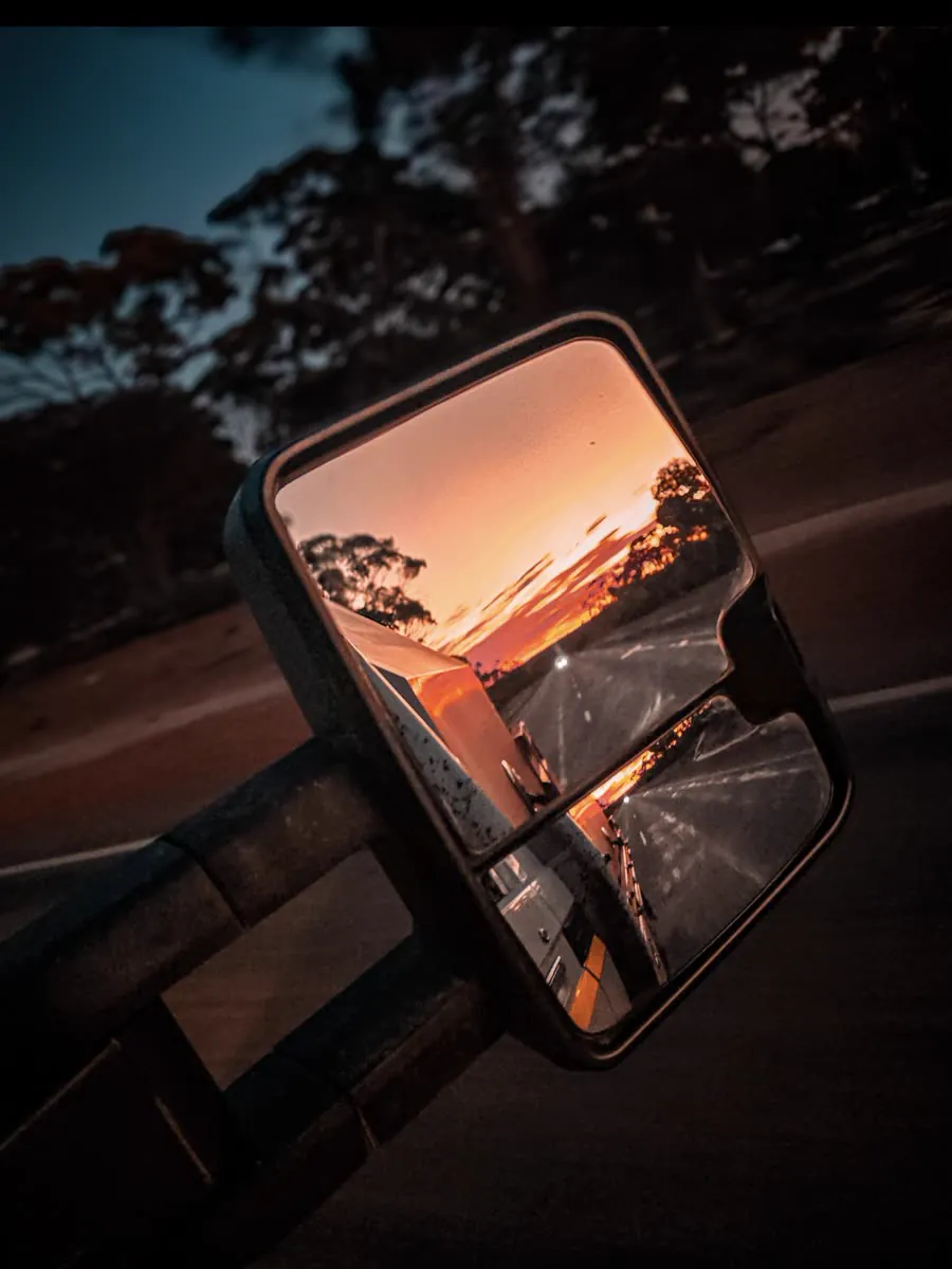 Sunset over the highway caught in the ute towing mirror