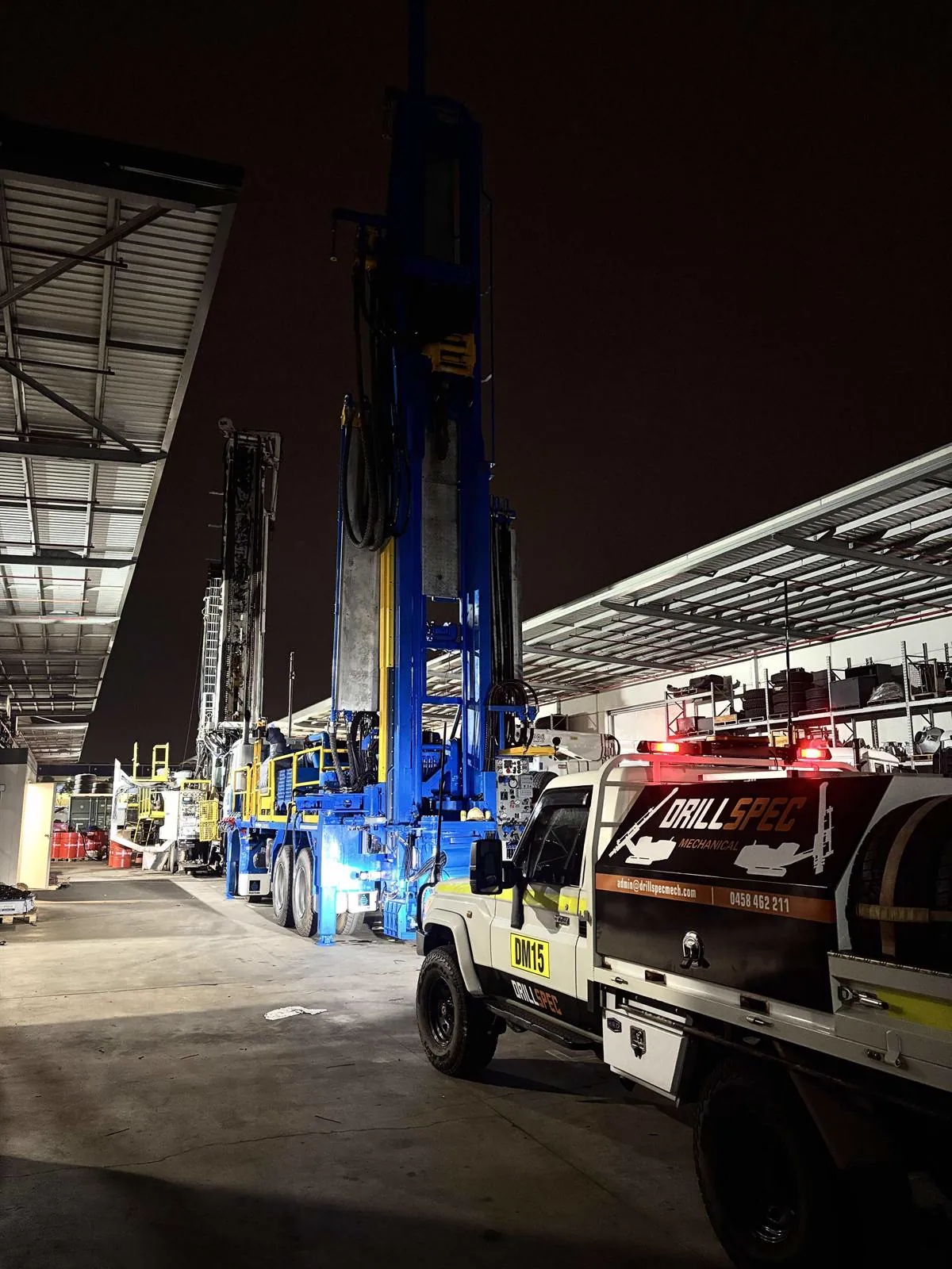 Drillspec DM15 service ute beside a drill rig at night