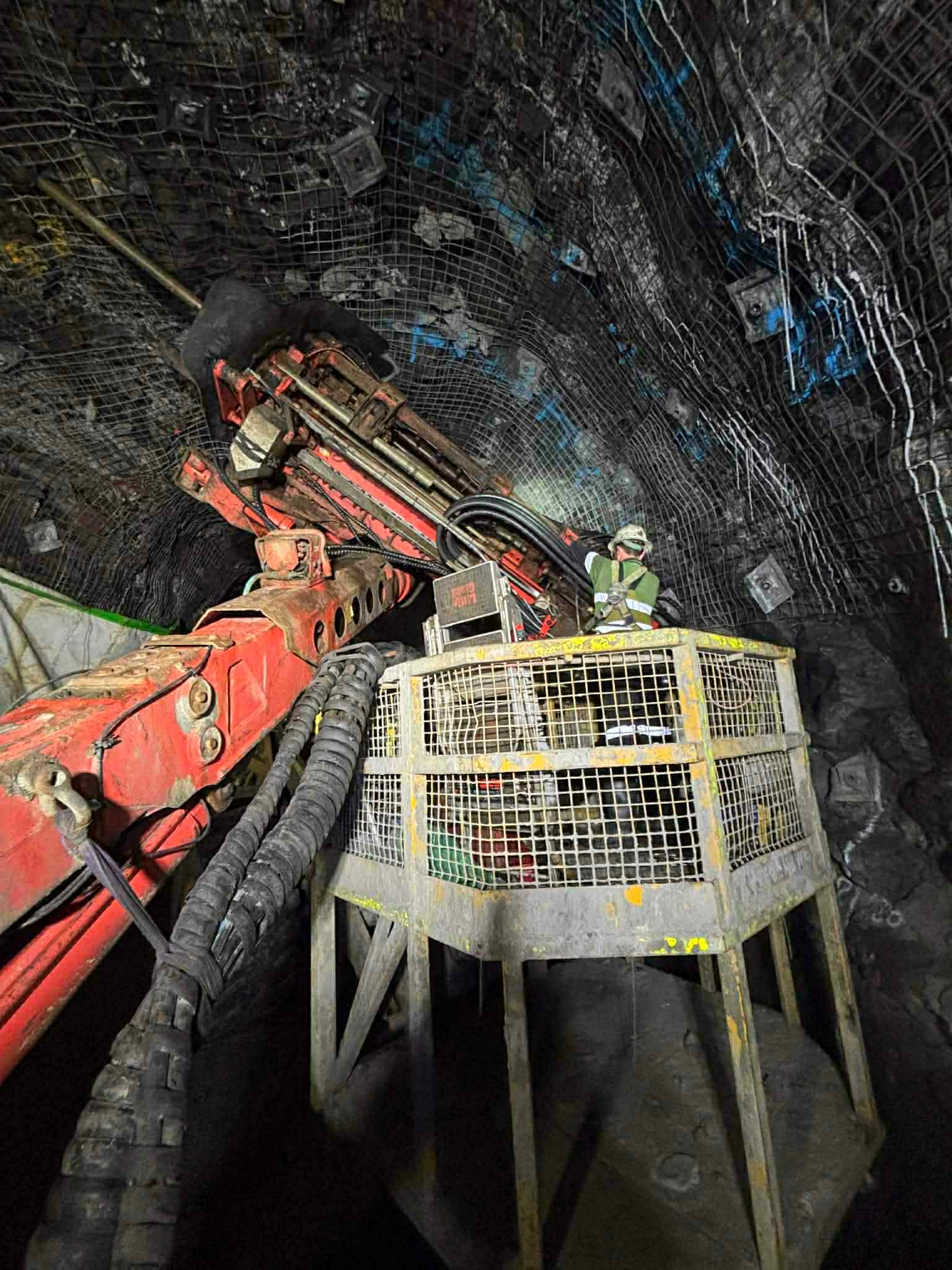 Underground jumbo drill rig at the face in a hard-rock decline