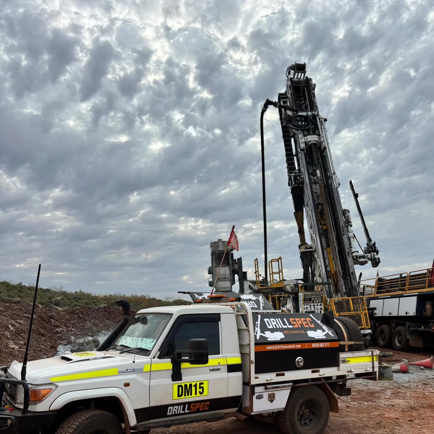 Drillspec DM15 service ute parked at the drill rig on arrival, cloudy Port Hedland sky